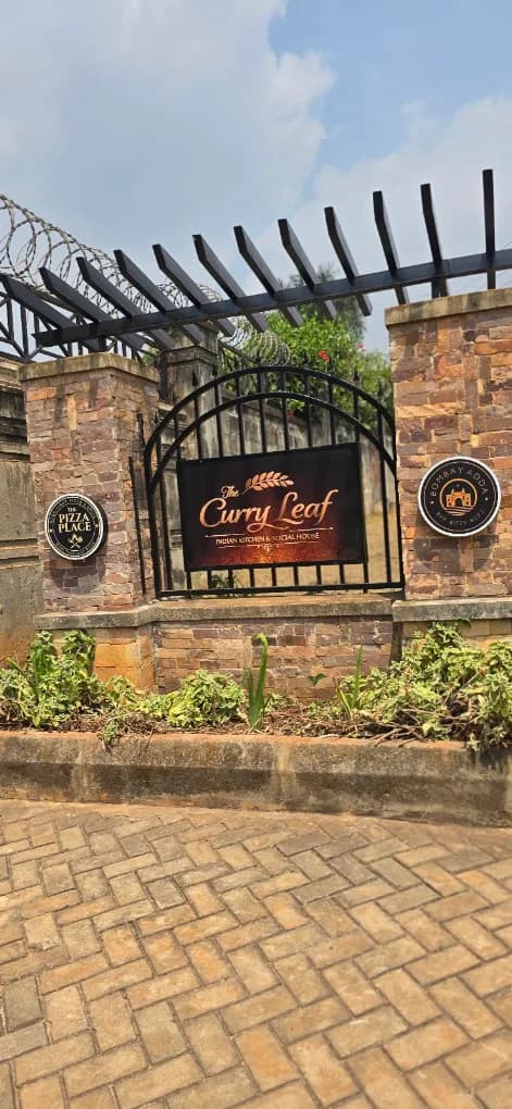 The Curry Leaf gate sign in Lubowa